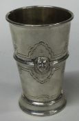A chased silver beaker embossed with lions. Birmingham 1930.