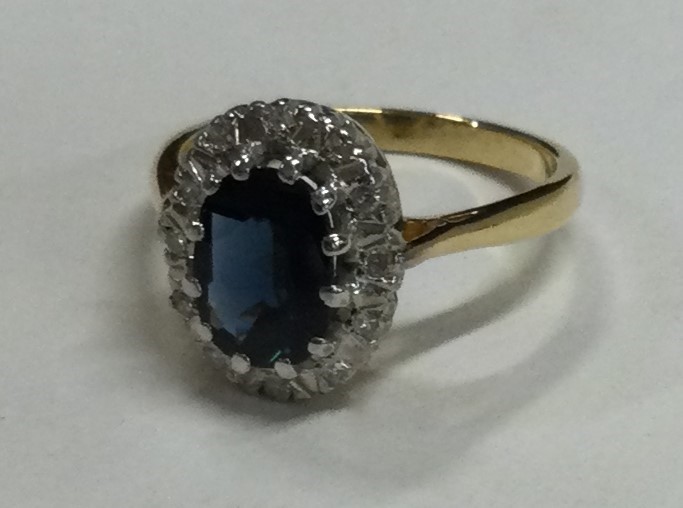 A large oval sapphire and diamond crossover ring in 18 carat gold setting. - Image 2 of 2