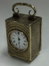 A silver gilt clock with engine turned decoration.