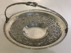WANG HING: A fine pierced 19th Century Chinese export silver swing-handled basket.