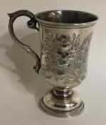 A chased Victorian silver christening mug. Birmingham 1874.