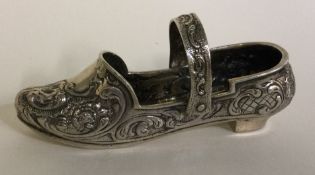 A German silver model of a shoe with adjustable handle.
