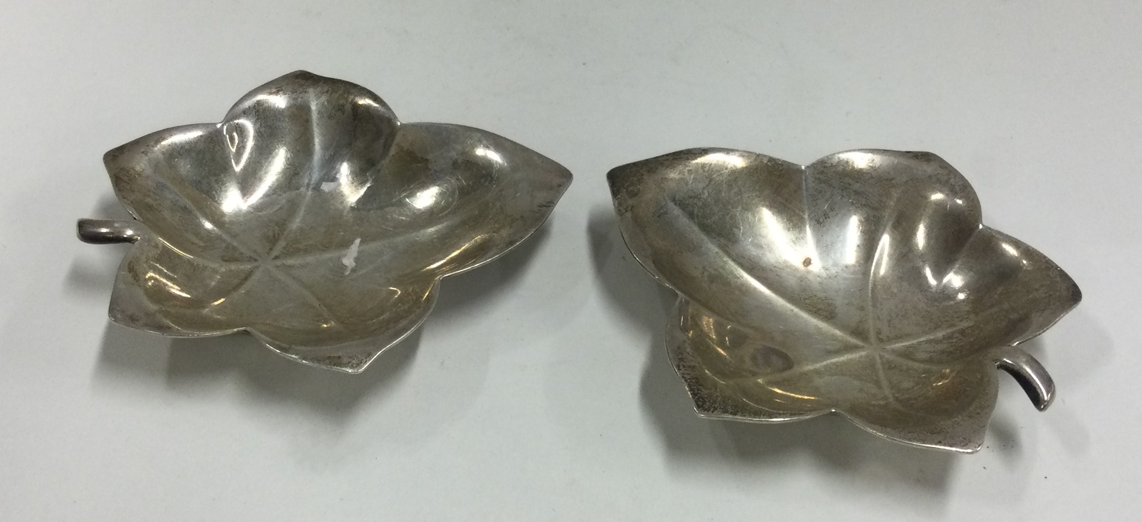 TIFFANY & CO: A pair of silver leaf dishes.