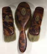 A 20th Century set of three gold mounted brushes.