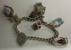 A heavy silver curb link charm bracelet.