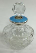 A silver and blue enamelled perfume bottle. 1929.