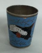 A silver plated and enamelled shot cup.
