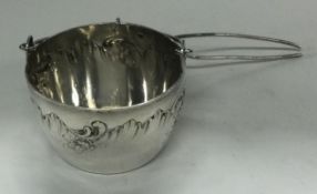 A French silver tea strainer with handle.