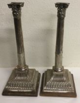 A large pair of 18th Century silver candlesticks on plinth. London 1769. By Walter Tweedie.