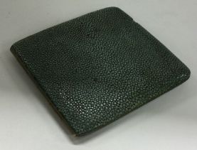 A nickel and shagreen cigarette case.