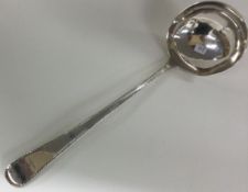 A bottom marked 18th Century crested silver soup ladle with feather edging.