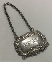 A Victorian silver wine label for 'Port' with grapevine border. By Yapp & Woodward.