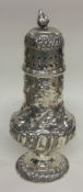 A Victorian silver sugar caster embossed with flowers. London 1897. By Josiah Williams & Co.