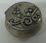 An Art Nouveau German silver pill box with hinged lid.