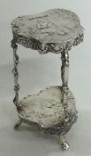 A 19th Century miniature silver table with embossed decoration, bearing import marks.