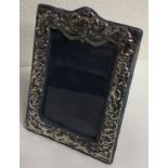 A chased silver picture frame. London 1985.