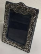 A chased silver picture frame. London 1985.