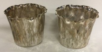 A pair of silver plated vases with bark finish. By Elkington & Co.