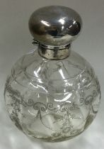 A massive silver mounted and etched glass dressing table bottle.