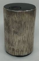 GUERNSEY: A Channel Islands silver table lighter with bark finish.