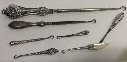 A large collection of silver mounted button hooks.