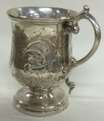 An Indian Colonial silver mug with engraved decoration. Marked to rim.