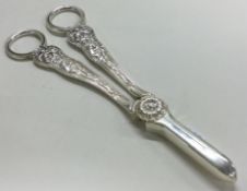 A pair of silver plated grape scissors with bacchanalia pattern and embossed decoration.