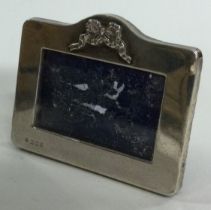 A silver frame with swag decoration.