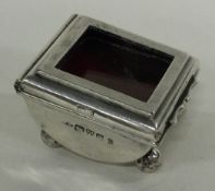 CHESTER: A small silver stamp box with hinged lid.
