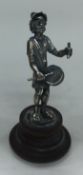 A silver musical figure on plinth bearing import marks.