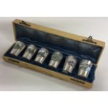 A rare French cased set of six silver and enamelled beakers. Marked to bases. Paris.