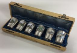 A rare French cased set of six silver and enamelled beakers. Marked to bases. Paris.