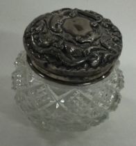 A chased silver and glass scent bottle.