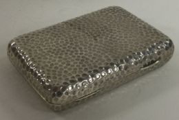 A novelty Victorian silver cigarette case of hammered design. London 1885. By Charles Fox.