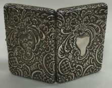 A Victorian chased silver card case embossed with flowers. Birmingham 1898.