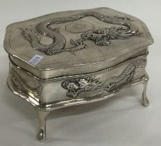 A heavy Chinese export silver jewellery box embossed with dragons. Circa 1900.