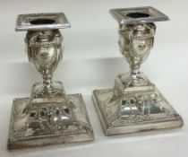 A good pair of chased silver plated candlesticks embossed with rams.