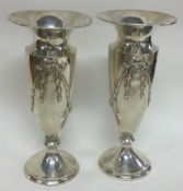 A pair of silver vases with swag decoration. London 1909. By Charles Davenport.