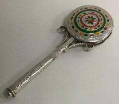 An unusual silver and enamelled rattle.