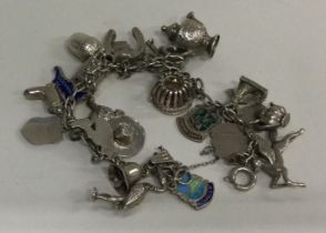 A heavy silver curb link charm bracelet.