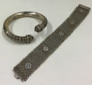 A heavy silver bracelet together with one other.