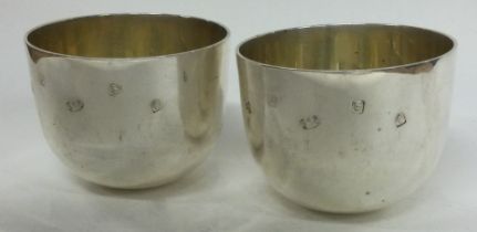 A pair of silver Britannia Jubilee tumbler cups.