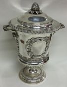 A large Victorian silver wine cooler with figural cover and embossed decoration. London 1899 / 1900.