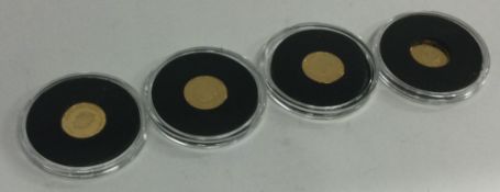 A group of four 22 carat gold proof coins.