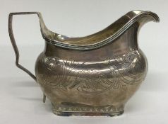 A George III silver jug with chased handle decorated with birds. London 1817. By Thomas Harper.