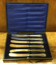 A set of six silver handled knives.