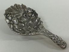 A Victorian silver caddy spoon chased with flowers. London 1891. By John Aldwinckle & James Slater.