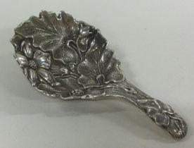 A Victorian silver caddy spoon chased with flowers. London 1891. By John Aldwinckle & James Slater.