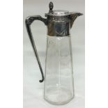 A German silver mounted cut glass claret jug with acorn finial.