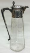 A German silver mounted cut glass claret jug with acorn finial.